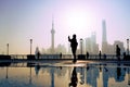Traveler take a photo of morning activity at the bund, huangpu riverside, shanghai city view background