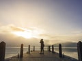 Traveler take picture on pier Lake outdoor sunrise Nature explorer