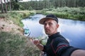 A traveler takes a selfie against the background of the river, rafting on a paddle Board on the Neman river