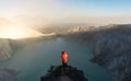 Traveler taking photograph on sightseeing point at kawah Ijen volcanic lake in the morning, famous tourist attraction and travel d