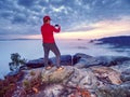 Traveler taking vacation mobile photos of beautiful sunset in autumn nature