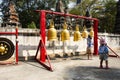 Traveler thai children girl and sisters walking travel visit and knell hit metal bell for respect praying blessing holy mystery Royalty Free Stock Photo