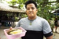 Traveler thai man holding and show durian fruit in fruits buffet festival