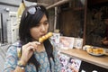 Traveler thai woman eating Mitarashi Dango japanese snack style Royalty Free Stock Photo