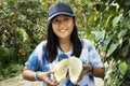 Traveler thai woman holding and show durian fruit in fruits buffet festival