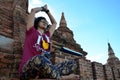 Traveler thai woman play yoka between wait sunset at Bagan