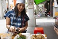 Traveler thai women eating chinese street food Fried Tofu with vegetables and sweet sauce at restaurant of old town at Chaozhou