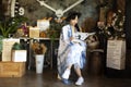 Traveler thai young women wear indigo tie dye paint shawl and scarf posing portrait sit read magazine book for take photo with