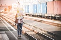 Traveler and tourist asian women wearing backpack holding map, waiting for a train.