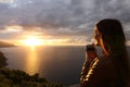 Traveler tourist girl taking photo in a sunset on the vacations