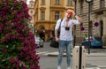 Traveler tourist man in casual clothes hat with suitcase. Man traveler with travel bag outdoor. Portrait of young Royalty Free Stock Photo