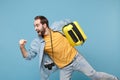Traveler tourist man in yellow clothes with photo camera isolated on blue background. Male passenger travele abroad on