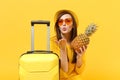 Traveler tourist woman in hat blowing sending air kiss hold fresh ripe pineapple fruit isolated on yellow orange