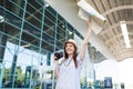 Traveler tourist woman hold retro vintage photo camera, paper map waving hand for greeting meeting friend and catch taxi Royalty Free Stock Photo