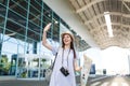 Traveler tourist woman with retro vintage photo camera, paper map waving hand for greeting, meeting friend and catch Royalty Free Stock Photo