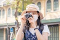 Traveler, travel asian young woman or girl use camera take photo old town street and city tourism on happy sunny day. Backpacker Royalty Free Stock Photo