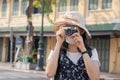 Traveler, travel asian young woman or girl use camera take photo, old town street, city tourism on happy sunny day. Backpacker Royalty Free Stock Photo