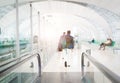 Traveler with travel bag or luggage walking in the airport terminal walkway for air traveling. blur motion Royalty Free Stock Photo