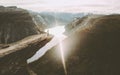 Traveler on Trolltunga cliff edge in Norway sunset mountains Royalty Free Stock Photo