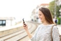 Traveler using a smartphone in a train station