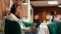 Traveler using tablet to pass time in lounge area at hotel Royalty Free Stock Photo