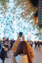 Traveler visiting Roppongi Hills Christmas Illumination and taking photo Tokyo tower, happy tourist woman stands on a christmas Royalty Free Stock Photo