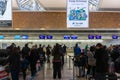 A traveler waiting to check-in before departure at New Chitose Airport, Hokkaido, Japan