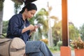 Traveler is waiting for train at the railway station. Women using smartphone for waiting train platform