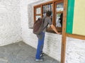 A traveler waits for information in a small tourist office