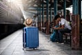 Traveler waits train at train station for travel in summer