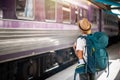 Traveler waits train at train station for travel in summer