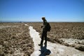 Traveler Walking on the Trail of Salar de Atacama, Extensive Chilean Salt Flat at the Altitude of 2,305 M. Royalty Free Stock Photo