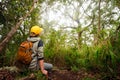 Traveler watching wild monkeys in the jungle.