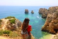 Traveler woman with backpack enjoying and relaxing stunning view Southern Portugal.