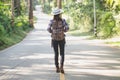 Traveler woman with backpack enjoying and walking on the road in tropical forest, chiang mai, chiang dao, Travel in Thailand, Royalty Free Stock Photo