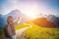 Traveler woman with backpack mountaineering and take a photo of Royalty Free Stock Photo