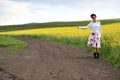 Traveler woman in dress hitchhiking in the countryside Royalty Free Stock Photo