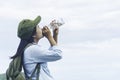 Traveler woman drinking with backpack enjoying sunset on peak mo