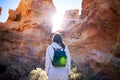 Traveler woman enjoy picturesque mountains in canyon backlit by Royalty Free Stock Photo