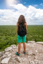 Traveler woman enjoys the view from the top of the Nohoch Mul pyramid in Coba Royalty Free Stock Photo