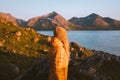 Traveler woman exploring Norway solo autumn season vacations adventure lifestyle outdoor sunset mountains