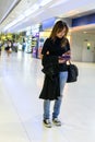 Traveler woman Female travelers holding mobile to check flights at the airport.