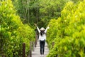 Traveler woman happy feeling freedom good and relax on the bridge wood in travel study nature forest