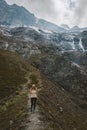 Traveler woman hiking alone in mountains travel active lifestyle adventure vacations outdoor Royalty Free Stock Photo