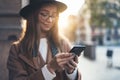 Traveler woman holding in hands mobile phone. Close up technology smartphone online connect. Girl tourist in glasses using gadget Royalty Free Stock Photo