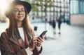 Traveler woman holding mobile phone. Close up technology smartphone online connect. Girl tourist in glasses using gadget cellphone Royalty Free Stock Photo