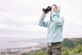 Traveler woman looking through binoculars outdoor. Royalty Free Stock Photo