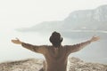 Woman with open arms hugging the surrounding nature