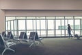 Traveler woman plan and backpack see the airplane at the airport glass window, girl tourist hold bag and waiting near luggage in h Royalty Free Stock Photo