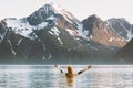 Traveler woman raised hands enjoying mountains Lyngen Alps view Royalty Free Stock Photo